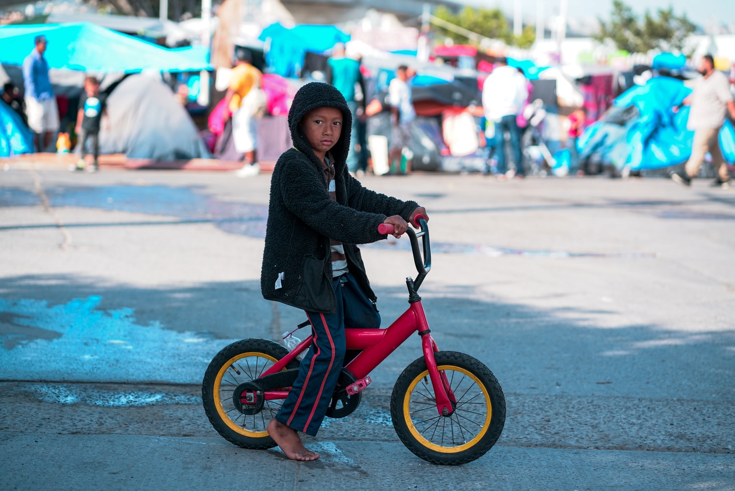 Refugee boy on bike at the border